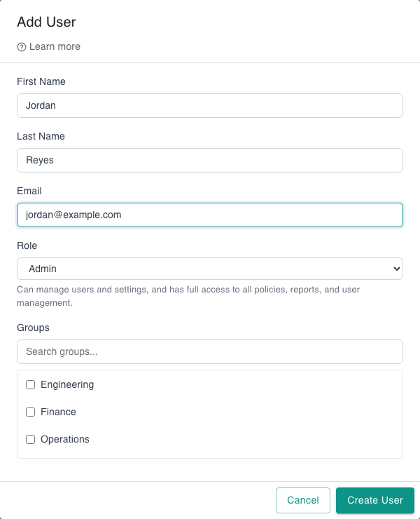 Add User modal with First Name, Last Name, and Email inputs filled with a synthetic sample user; Role dropdown set to Admin with the helper text describing admin access; a Groups picker below; Cancel and Create User buttons in the footer